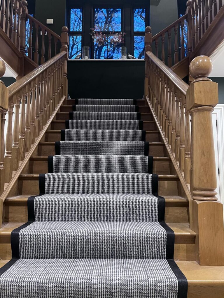 Staircase with carpet runner.