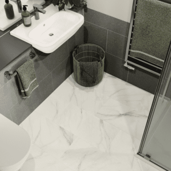Bathroom setting with light marble flooring.
