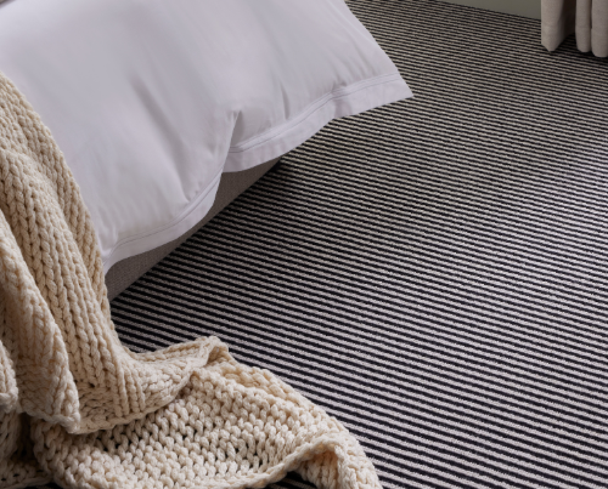 Room setting with bedroom and striped carpet